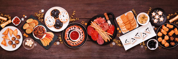 istock New Years Eve appetizer table scene. Top view on a dark wood banner background. 1442799199