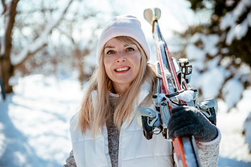 Happy Woman skier in winter ski vacation on snowy mountain. Copy space
