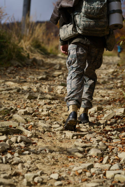 istock A soldier wandering with a backpack on a mountain trail 1442799629