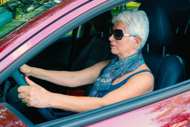 istock Lady in a red car 1442799947