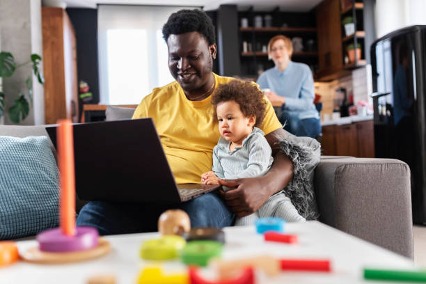 istock Father spending time with a cute daughter watching laptop computer with her. Multicultural family. Educational apps for small kids. 1442802254