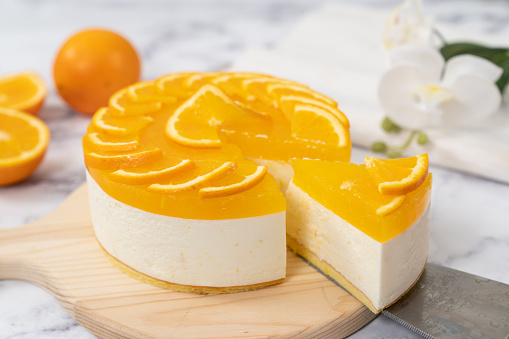 Homemade non baked orange cheesecake with fresh orange slices decoration
