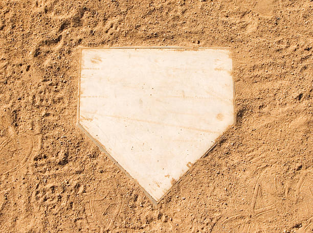 Clean baseball home plate set in dirt stock photo