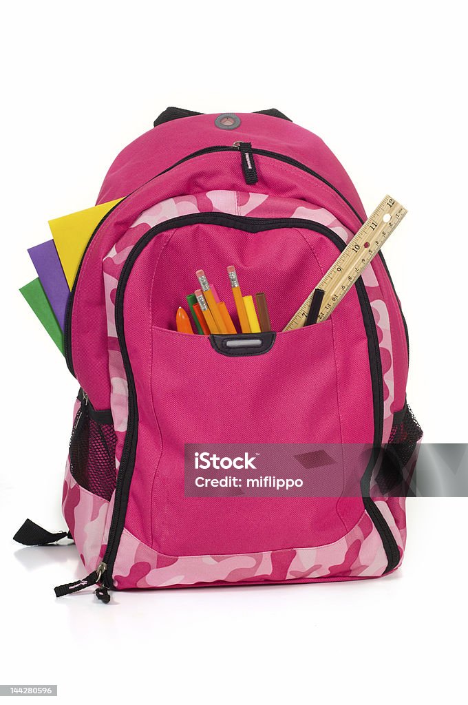 Pink school backpack with supplies Pink decorative backpack or bookbag with school supplies Autumn Stock Photo