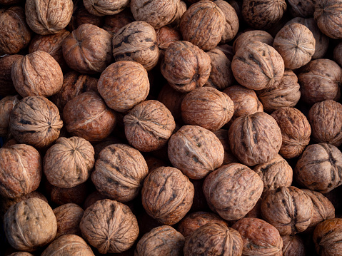 A box of new season wet walnuts in a box outside a greengrocer’s shop in Swaffham, Norfolk, England.