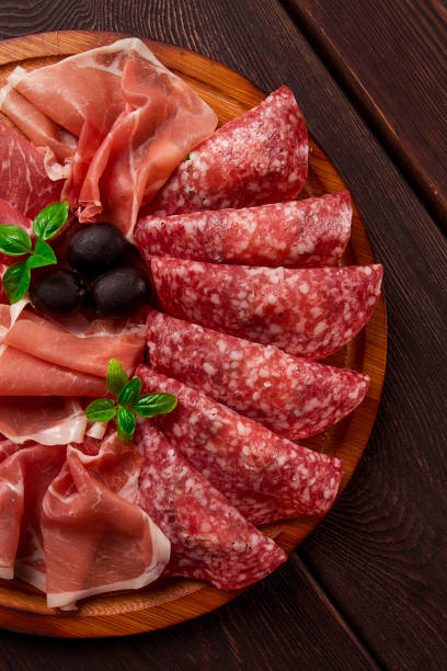 istock Assortment , sliced meat appetizer, prosciutto, salami and ham, with olives, breakfast, top view, close-up, no people, 1442806509