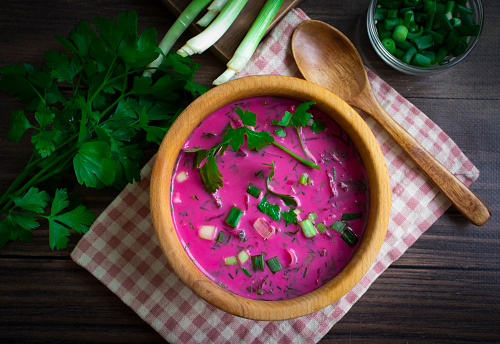 Cold beetroot soup on wooden background