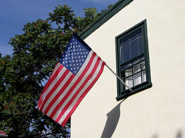 istock USA flag hanging from window sill. 144281383