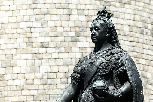 Queen Victoria memorial bronze statue outside Windsor Castle in Berkshire, England, UK which is a popular tourist holiday travel destination and landmark attraction, stock photo image