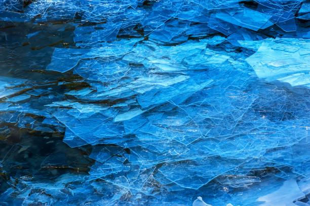 Ice surface of the river. The texture of fragments of ice and water during the icing period. Winter background. stock photo