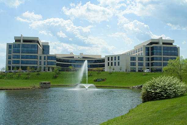 Large Modern Office Building Pond Fountain Grass Suburban Maryland, USA Office building in Maryland - See lightbox for more office park stock pictures, royalty-free photos & images