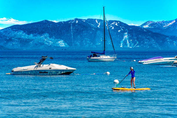 Paddle board - Lake Tahoe A woman on a paddle board on Lake Tahoe against a mountain backdrop. She is in proximity of moored pleasure boats.
Lake Tahoe, California, USA
06/27/2022 robert michaud stock pictures, royalty-free photos & images