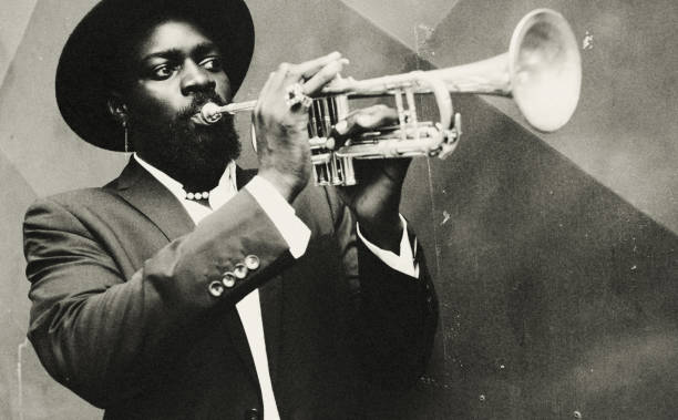 JAZZ! Portrait of a black jazz musician. He plays in a secret jazz club in the heart of the city. man trumpet stock pictures, royalty-free photos & images