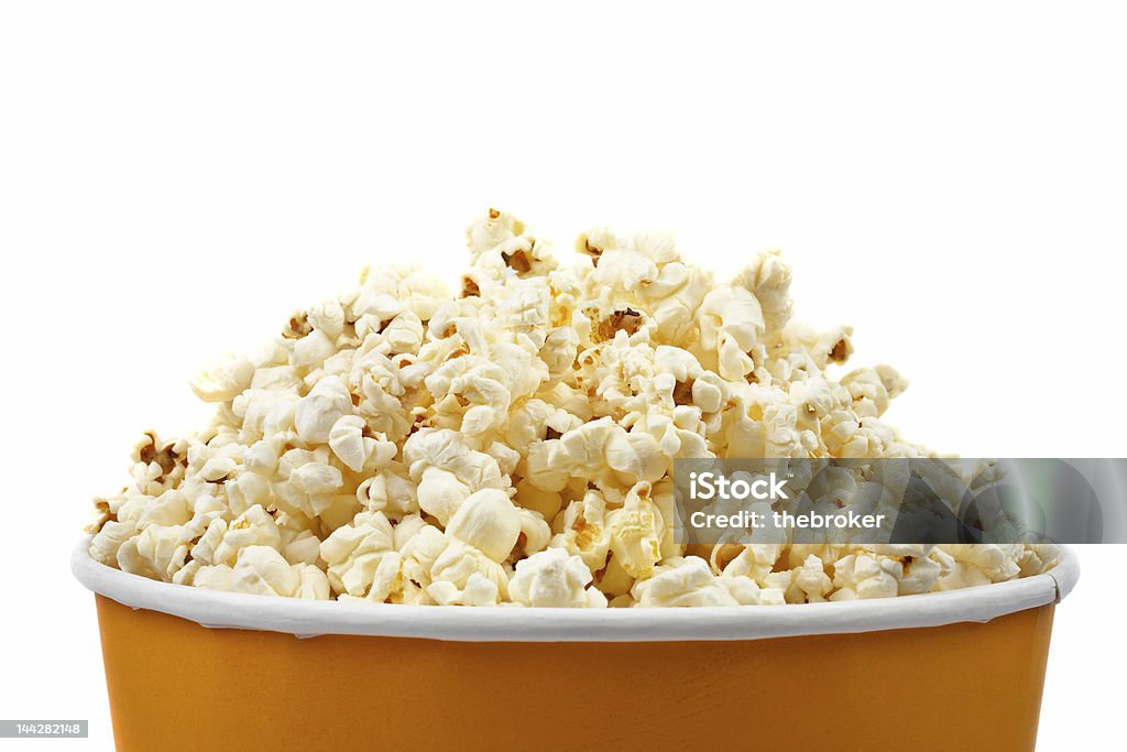 Popcorn in a bucket at a movie theater Detail of popcorn in a bucket over a white background Arts Culture and Entertainment Stock Photo