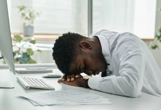 istock Tired businessman sleeping at workplace 1442822581