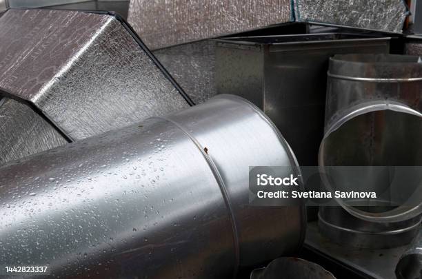 Metalic Shiny Industrial Background With Cylinder Ventilation Tubes Stacked After Dismantling Abstract Pile Of Aluminium Staff Renovation Of Ventilation System Stock Photo - Download Image Now