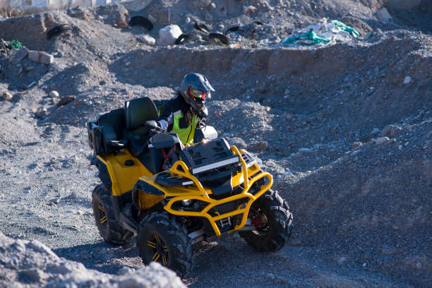 istock Woman driving ATV on dirt road 1442823570