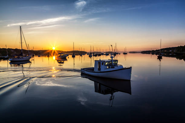 Fishing Boat Stirring at Dawn in Mahone Bay Nova Scotia stock photo