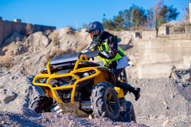 istock Woman driving ATV on dirt road 1442823825