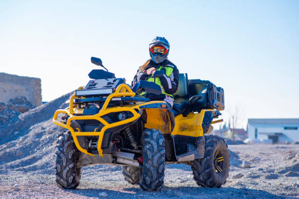 istock Woman driving ATV on dirt road 1442824361