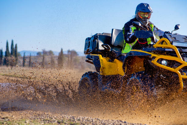 istock Woman driving ATV on dirt road 1442824594