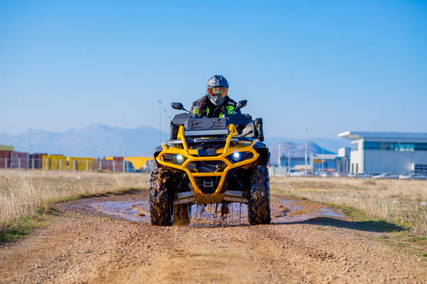 istock Woman driving ATV on dirt road 1442824685