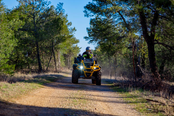 istock Woman driving ATV on dirt road 1442825672