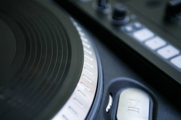 istock Vinyl record on dj turntable. Disc jockey player device on stage. Professional disk jokey turntables and sound mixer 1442825891