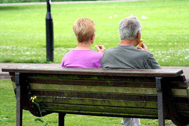 istock Retired couple eating ice-cream in the park 144282976
