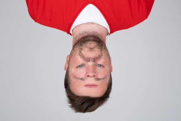 Portrait on caucasian man with face uside down. I feel strange concept. Mental disorder.