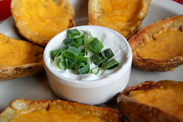 Baked potato skins loaded with cheese stock photo