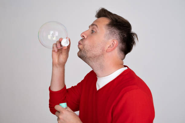 istock A mature man inflates soap bubbles like a child 1442832285