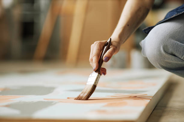 istock Selective focus on hand of young creative woman with paintbrush 1442832596
