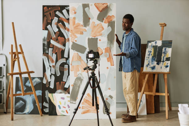 istock Young confident African American painter making presentation of his collection 1442832598