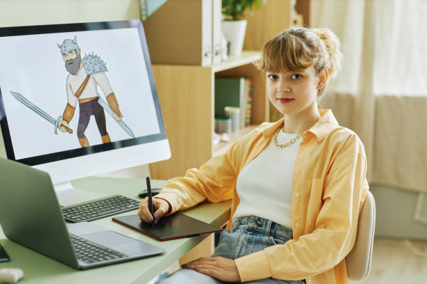 istock Young pretty female designer looking at camera while drawing 1442832630