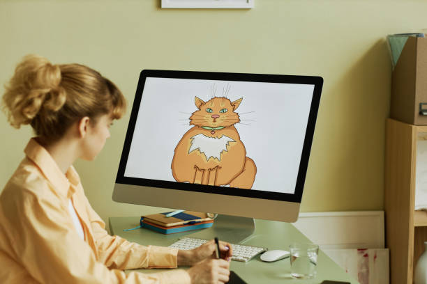 istock Focus on computer screen with fat ginger cat drawn by digital artist 1442832664