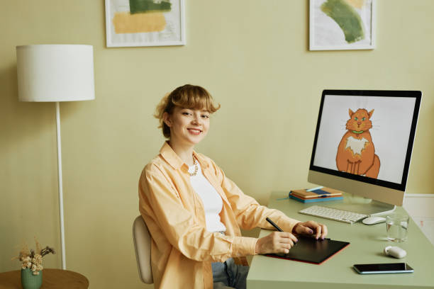 istock Young successful blond woman with stylus and graphic tablet 1442832673