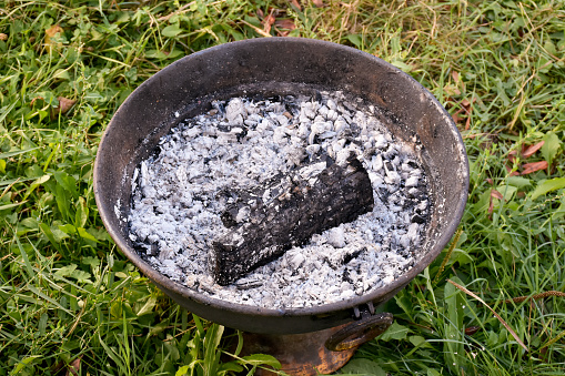 Burnt firewood and ashes in barbecue