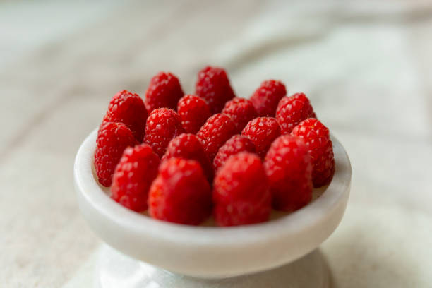 istock Raspberry close-up on a beautiful stand, summer fruit. 1442835017