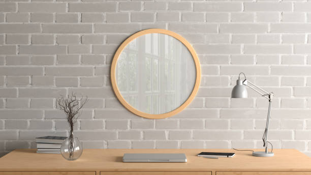 istock Wooden round poster frame mock up on the brick wall of home studio workspace. Front view. 1442835141