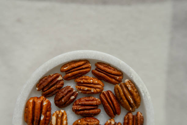 istock Walnut plan, pecan halves on a beautiful stand, Nuts are healthy. 1442835233