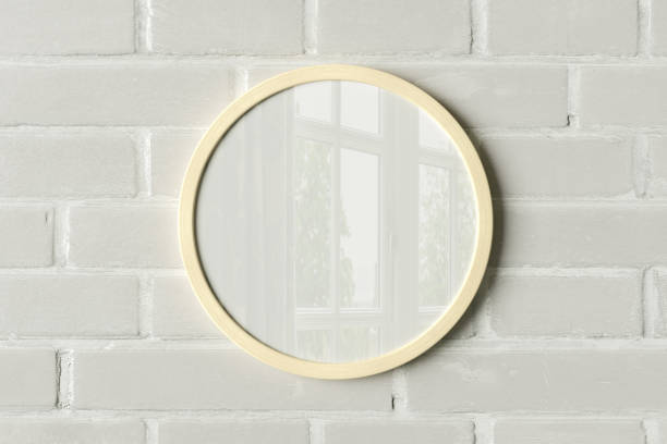 istock Wooden round frame poster mock up on the white brick wall. 1442835490