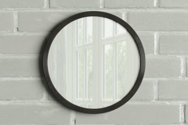istock Dark wooden round frame poster mock up on the white brick wall. 1442835542