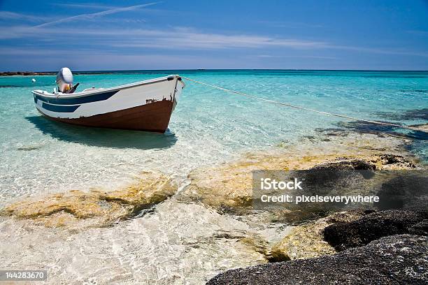 Single Boat Sitting Off The Coast Stock Photo - Download Image Now - After Work, Beach, Blue