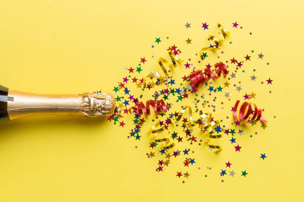 istock Creative flat lay composition with bottle of champagne and space for text on color background. Champagne bottle with colorful party streamers. holiday or christmas concept 1442837464