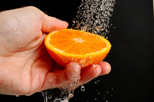 Washing an orange stock photo