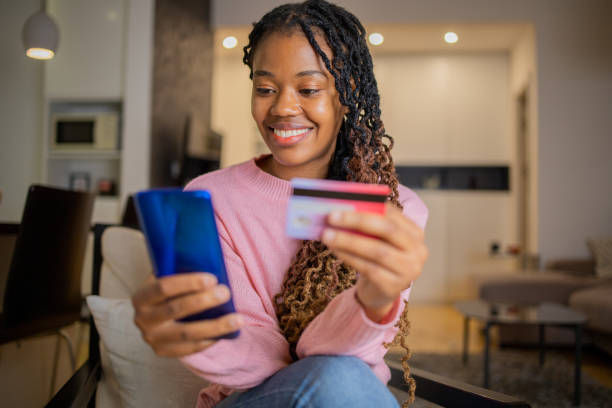 istock Cheerful  woman doing online shopping 1442838770