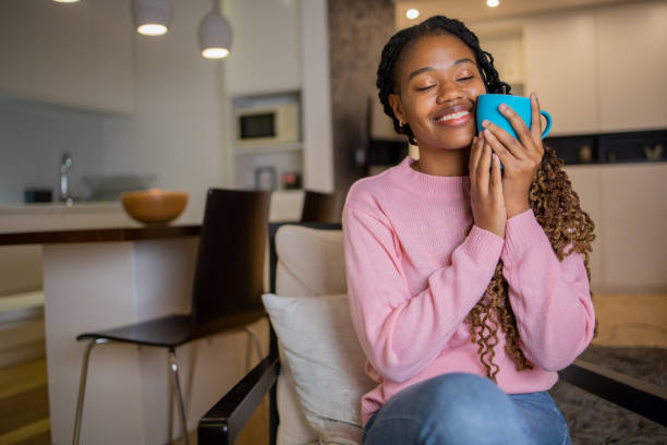 istock Woman having coffee and relaxing at home 1442838995