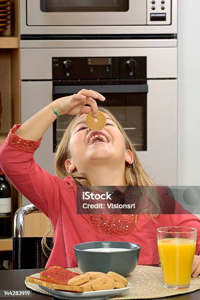 Young Girl Having Breakfast Stock Photo - Download Image Now - Breakfast, Child, Cookie