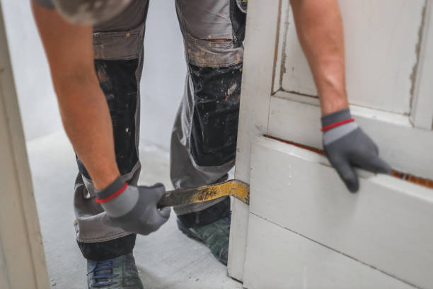 istock Hands of a man working with a crowbar indoors. 1442842418